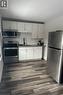 Kitchen featuring white cabinets, dark hardwood / wood-style floors, sink, and appliances with stainless steel finishes - 1090 Cannon Street E, Hamilton, ON  - Indoor Photo Showing Kitchen 