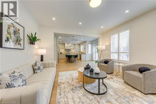 Bright living area featuring light-colored flooring, recessed lighting, and large windows with plantation shutters - 4267 Sarazen Drive, Burlington, ON - Indoor Photo Showing Living Room