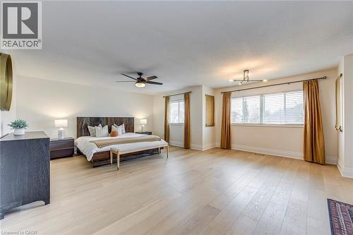 Bright and spacious room featuring light-colored hardwood flooring and multiple windows with blinds, allowing for natural light - 4267 Sarazen Drive, Burlington, ON - Indoor Photo Showing Bedroom