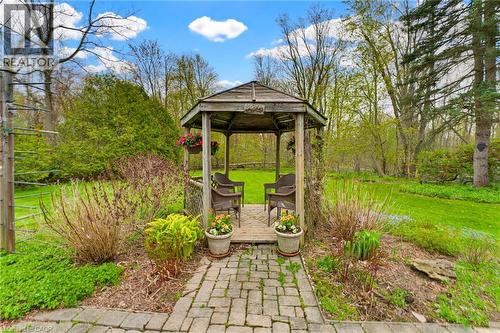 Wood gazebo with a slatted roof and a wood deck base, featuring a paver stone pathway - 10 Huisman Lane, Hamilton, ON - Outdoor With Backyard