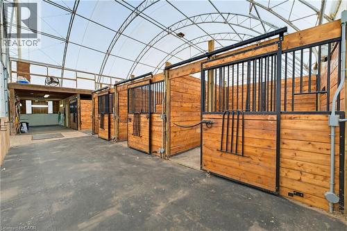equestrian facility featuring 4 10'x12' hardwood box stalls with rubber matting - 10 Huisman Lane, Hamilton, ON - Indoor Photo Showing Other Room