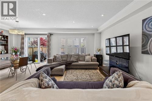 Open-concept living area with light wood-finish flooring, recessed lighting, and crown molding - 4236 Prudham Avenue, Burlington, ON - Indoor Photo Showing Living Room