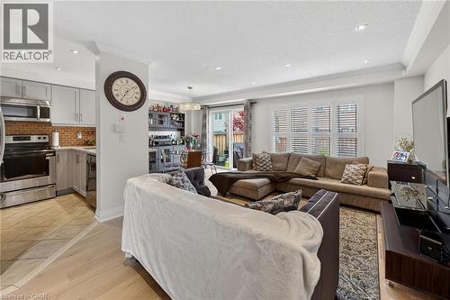 Open-concept living area featuring light wood-finish flooring, recessed lighting, and a white ceiling - 4236 Prudham Avenue, Burlington, ON - Indoor