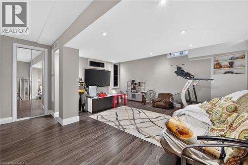 Spacious room featuring wood-finish flooring, recessed lighting, and light gray walls - 4236 Prudham Avenue, Burlington, ON - Indoor