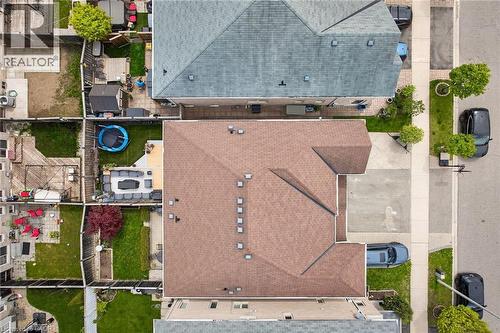 Aerial overview showcasing a property with a brown shingle roof, a paved driveway, and a concrete patio - 4236 Prudham Avenue, Burlington, ON - Outdoor