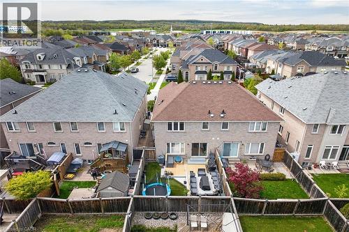 Rear exterior featuring brick facade, private backyard with wooden fencing, and a multi-level deck - 4236 Prudham Avenue, Burlington, ON - Outdoor