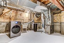 Utility space featuring a washer, laundry sink, and water treatment system - 