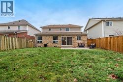 Expansive grassy yard with wood fencing and a concrete patio - 