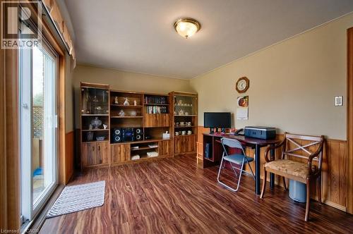 Wood-finish flooring throughout, complemented by a built-in wooden shelving unit with integrated display cases - 34 Westwood Crescent, Kitchener, ON - Indoor