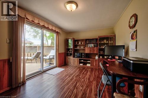 Interior space with wood-finish flooring and sliding glass doors opening to an exterior deck - 34 Westwood Crescent, Kitchener, ON - Indoor Photo Showing Office