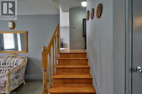 Solid wood staircase with turned wood balusters and a matching handrail - 34 Westwood Crescent, Kitchener, ON - Indoor Photo Showing Other Room