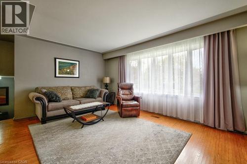 Expansive window with sheer and blackout drapery - 34 Westwood Crescent, Kitchener, ON - Indoor Photo Showing Living Room