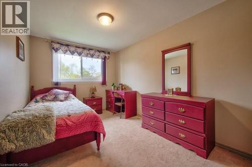 Neutral tone wall paint, carpet flooring, and a large window with natural light - 34 Westwood Crescent, Kitchener, ON - Indoor Photo Showing Bedroom