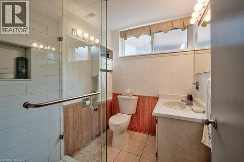 Bathroom featuring a glass-enclosed shower with white subway tile, a built-in shower niche, and a grab bar - 34 Westwood Crescent, Kitchener, ON - Indoor Photo Showing Bathroom