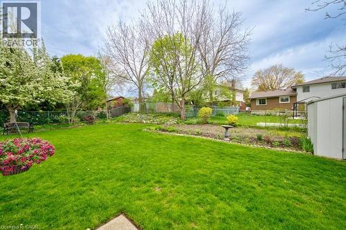 Expansive green lawn with mature trees and established garden beds - 34 Westwood Crescent, Kitchener, ON - Outdoor With Backyard