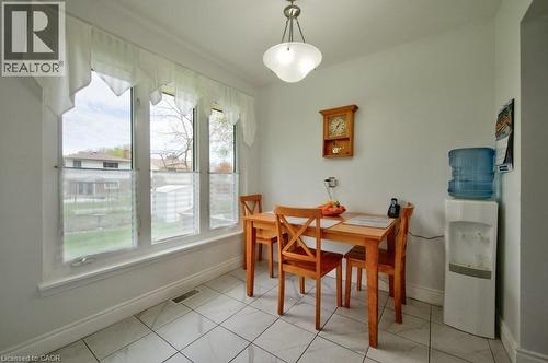 Bright room featuring a three-panel window, white trim, and square tile flooring - 34 Westwood Crescent, Kitchener, ON - Indoor Photo Showing Dining Room