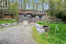 Split-level home featuring a gravel driveway and stone retaining walls - 1333 Hidden Valley Road, Burlington, ON  - Outdoor 