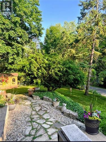 Stone pathway with gravel accents, surrounded by lush green landscaping - 1333 Hidden Valley Road, Burlington, ON - Outdoor