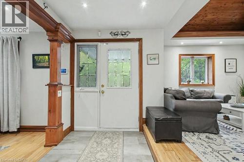 Entryway featuring a white door with decorative glass inserts, an adjacent vertical window, and recessed lighting - 1333 Hidden Valley Road, Burlington, ON - Indoor