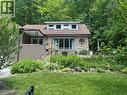 Stone veneer and horizontal siding exterior with a dormer featuring multiple windows - 1333 Hidden Valley Road, Burlington, ON  - Outdoor 