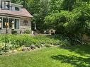 Expansive terraced yard featuring mature landscaping, a stone retaining wall, and a multi-level patio - 1333 Hidden Valley Road, Burlington, ON  - Outdoor 