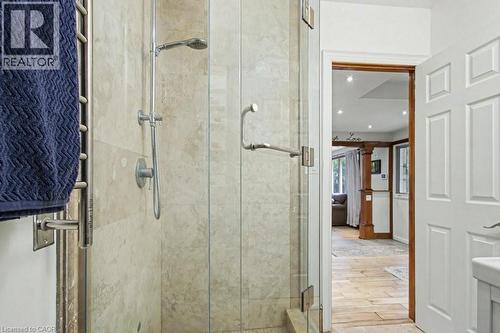 Glass-enclosed shower with stone-look tile surround and a rainfall showerhead - 1333 Hidden Valley Road, Burlington, ON - Indoor Photo Showing Bathroom