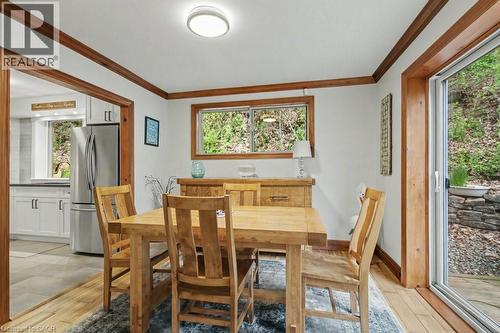 Dining area featuring wood-finish flooring and trim, with a sliding glass door providing outdoor access - 1333 Hidden Valley Road, Burlington, ON - Indoor Photo Showing Dining Room