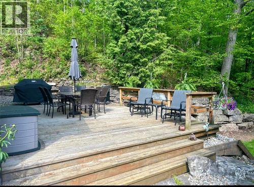 Expansive outdoor wood deck with multiple levels, bordered by a stone wall - 1333 Hidden Valley Road, Burlington, ON - Outdoor With Deck Patio Veranda