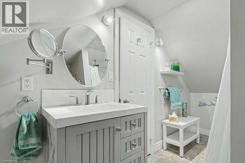 Bathroom featuring a grey vanity with integrated sink, chrome faucet, and overhead lighting - 1333 Hidden Valley Road, Burlington, ON - Indoor Photo Showing Bathroom