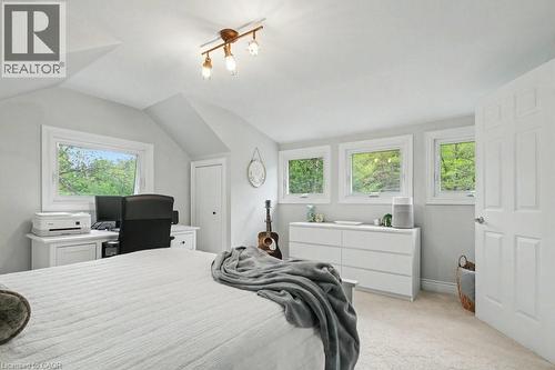 Room featuring four windows with white trim, light gray walls, and light-colored carpeting - 1333 Hidden Valley Road, Burlington, ON - Indoor Photo Showing Bedroom