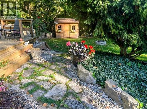 Outdoor wood deck featuring steps down to a stone patio with gravel accents - 1333 Hidden Valley Road, Burlington, ON - Outdoor With Deck Patio Veranda