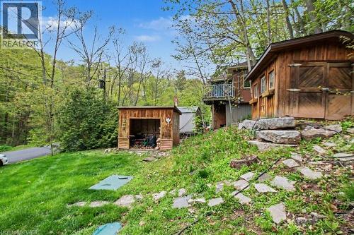 Terraced landscape featuring a stone-stepped pathway, lush green lawn, and mature trees - 1333 Hidden Valley Road, Burlington, ON - Outdoor