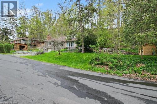 Stone-clad residence featuring multiple large windows and an integrated garage - 1333 Hidden Valley Road, Burlington, ON - Outdoor