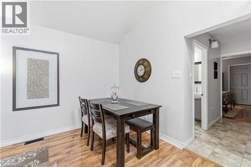 Open concept area with wood-finish flooring, white baseboards, and bright white walls - 74 Province Street N, Hamilton, ON - Indoor Photo Showing Dining Room