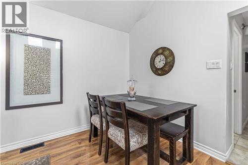 Dining area featuring wood-finish flooring, white baseboards, and bright white walls - 74 Province Street N, Hamilton, ON - Indoor Photo Showing Dining Room