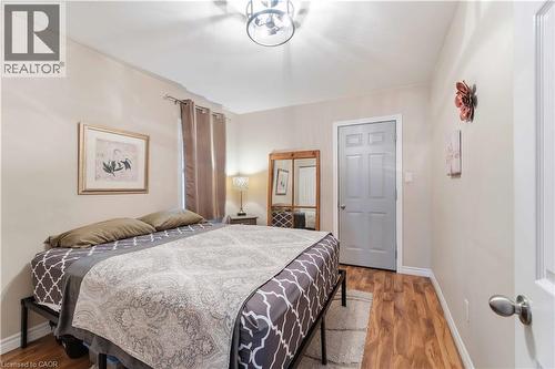 Interior room with wood-finish flooring and light-toned walls - 74 Province Street N, Hamilton, ON - Indoor Photo Showing Bedroom