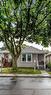 Single-story residence featuring light gray siding, a gabled roof, and a mature front yard tree - 74 Province Street N, Hamilton, ON  - Outdoor 