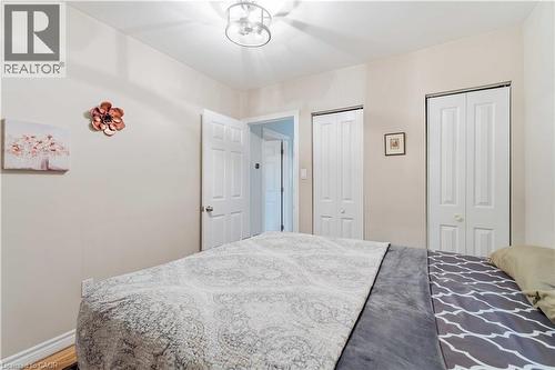 Light-toned walls with contrasting white trim and doors - 74 Province Street N, Hamilton, ON - Indoor Photo Showing Bedroom
