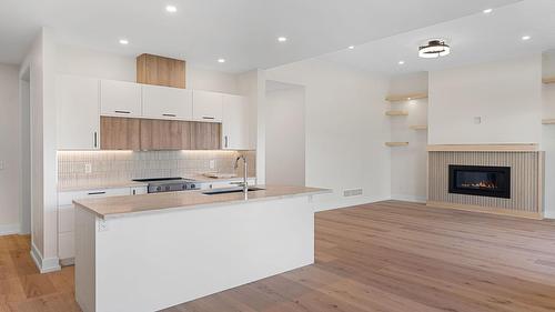 2140 Montenegro Drive, Kelowna, BC - Indoor Photo Showing Kitchen With Fireplace With Double Sink