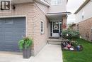 Brick and siding exterior featuring a single-car garage with transom windows - 70 Queen Charlotte Crescent, Kitchener, ON  - Outdoor With Exterior 
