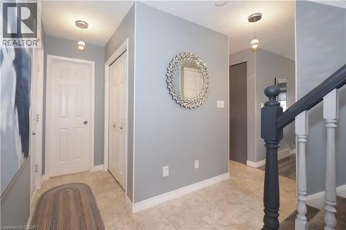 Foyer featuring light gray walls, tile flooring, white baseboards, and a white six-panel door - 70 Queen Charlotte Crescent, Kitchener, ON - Indoor Photo Showing Other Room