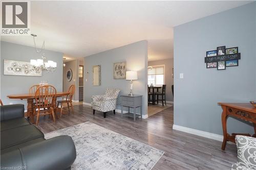 Living area featuring wood-finish flooring, light gray wall paint, and white baseboards - 70 Queen Charlotte Crescent, Kitchener, ON - Indoor Photo Showing Living Room