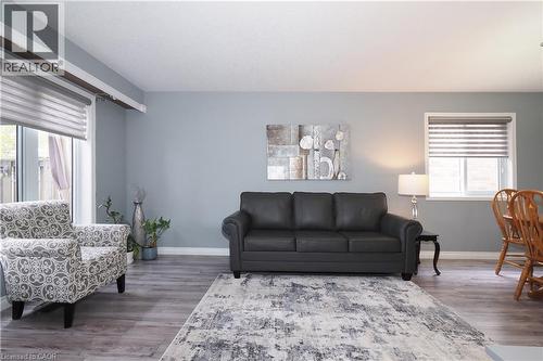 Living area featuring wood-finish flooring, light grey walls, and white trim - 70 Queen Charlotte Crescent, Kitchener, ON - Indoor Photo Showing Living Room
