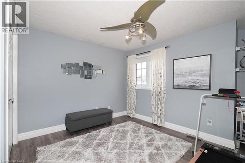 Wood-finish flooring with white baseboards, a window with white trim, and a ceiling fan with integrated lighting - 70 Queen Charlotte Crescent, Kitchener, ON - Indoor