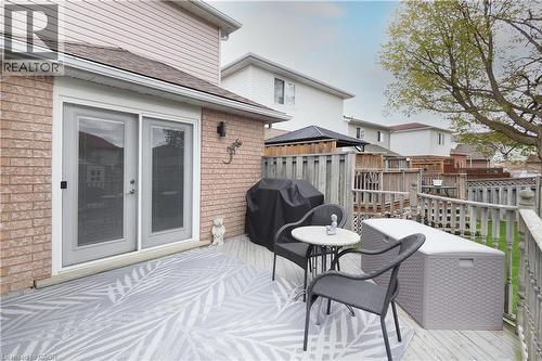 Outdoor deck area featuring wood-finish decking, brick exterior siding, and a white framed double door with glass panels - 70 Queen Charlotte Crescent, Kitchener, ON - Outdoor With Deck Patio Veranda With Exterior