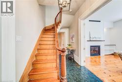 Curved wooden staircase with baluster railing - 