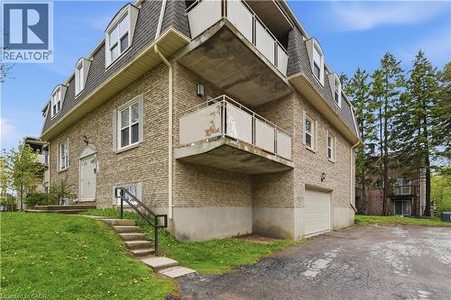 Brick exterior featuring a Mansard roofline, dormer windows, and multiple balconies - 91 Westmount Road Unit# 3, Waterloo, ON - Outdoor With Exterior