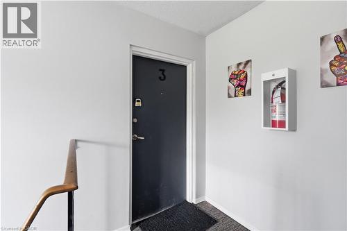 Black entry door with silver hardware and visible unit number - 91 Westmount Road Unit# 3, Waterloo, ON - Indoor