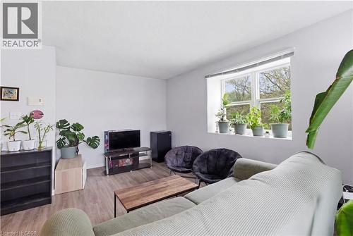 Bright interior space featuring a window with multiple panes, light-toned walls, and wood-finish flooring - 91 Westmount Road Unit# 3, Waterloo, ON - Indoor
