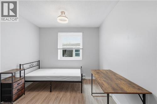 Room featuring light wood-finish flooring, white walls, and a single window with blinds - 91 Westmount Road Unit# 3, Waterloo, ON - Indoor